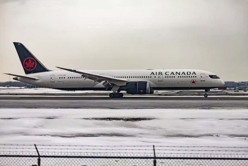 Plane takes off during a snowy day at Seattle-Tacoma International Airport.